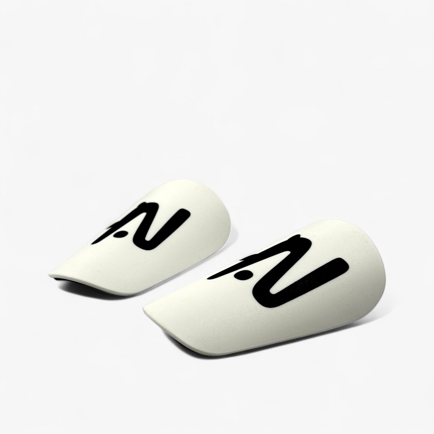 Two white midi shin guards with black logo on a white background