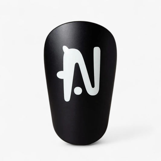 Black NTMG mini shin guard with a white logo on a light gray background
