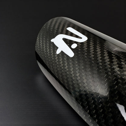 Carbon fiber surface with a white logo on a black background