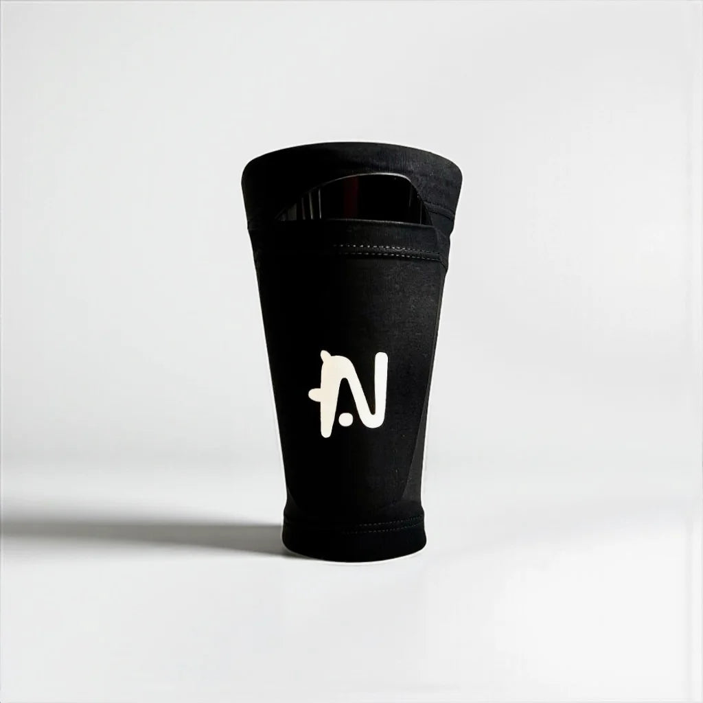 Black NTMG Original sleeve with a logo on a white background. NTMG Classic shin guard is inserted in the sleeve.
