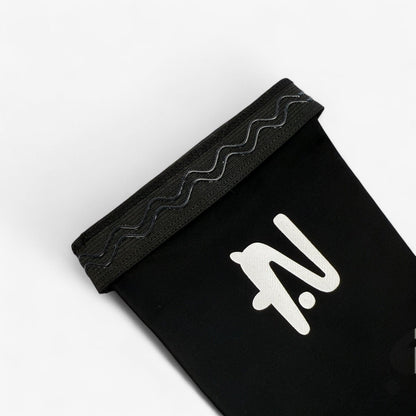 Black sleeve with a white logo on a light grey background. The silicone lip that holds the sleeve in place is showing.