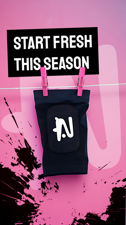 Black shin pad with NTMG logo hanging on a washing line on a pink background with text 'Start Fresh This Season'.